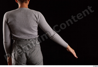 Zahara  1 arm back view dressed flexing grey sweatshirt…